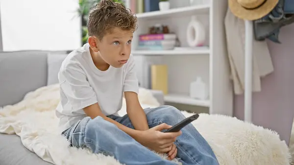 Adorable Blond Kid Wearing Bored Expression Comfortably Hustling Sofa Home — Stock Photo, Image