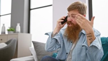İrlandalı kızıl saçlı adam, oturma odasında oturmuş, akıllı telefonuyla yaptığı konuşmadan dolayı stresliydi, hayal kırıklığı ve umutsuzlukla savaşıyordu.