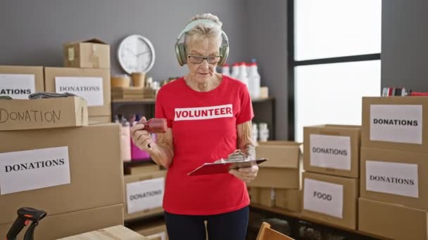 Devoted Senior Grey Haired Woman Volunteer Listens Uplifting Music While — Stock Video
