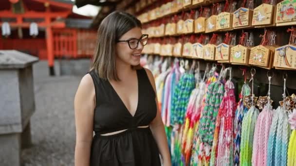 Cheerful Brunette Hispanic Woman Wearing Glasses Smiles Traditional Japanese Ema — Stock Video