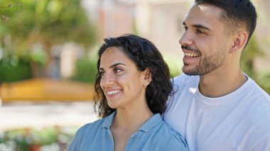 Man and woman couple smiling confident standing together at park