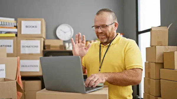 stock image Caucasian man volunteer smiling confident having video call at charity center