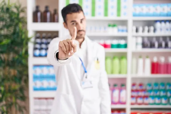 Handsome Hispanic Man Working Pharmacy Drugstore Pointing Finger Angry Expression — Stock Photo, Image