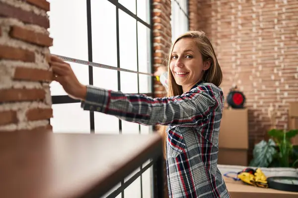Young Blonde Woman Smiling Confident Measuring Window New Home — Foto de Stock