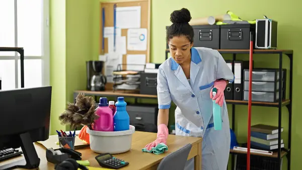 African american woman clean professional cleaning table at office