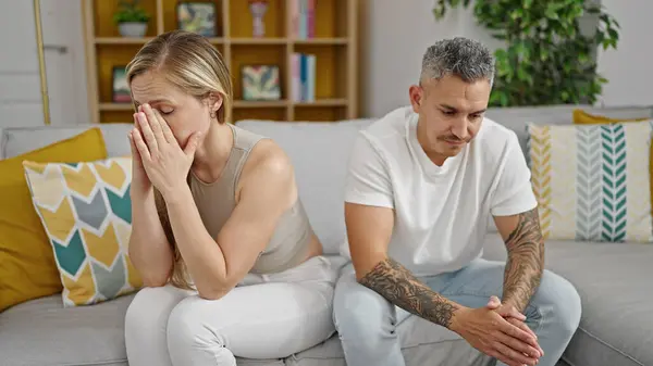 Man and woman couple stressed sitting on sofa at home