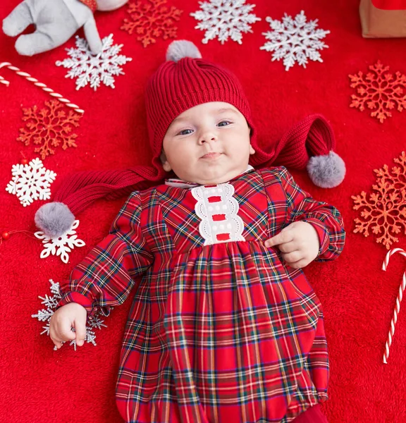 Adorable Caucasian Baby Lying Floor Christmas Decor Isolated Red Background — Stock Photo, Image