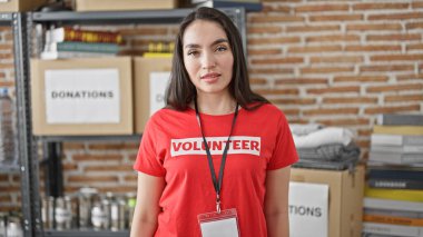 Genç ve güzel İspanyol kadın gönüllü hayır kurumunda rahatça ayakta duruyor.