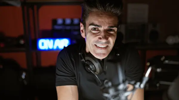 Young hispanic man radio reporter smiling confident at radio studio