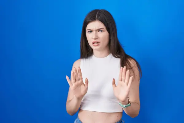 Young Caucasian Woman Standing Blue Background Moving Away Hands Palms — Stockfoto