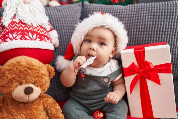 Adorable Hispanic Toddler Wearing Christmas Hat Bitting Star Decoration Home — Stock Photo, Image