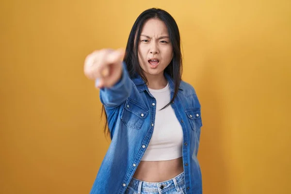 Young Asian Woman Standing Yellow Background Pointing Displeased Frustrated Camera —  Fotos de Stock