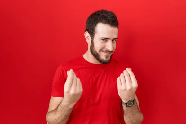Young Hispanic Man Wearing Casual Red Shirt Doing Money Gesture — Stock Photo, Image