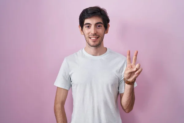 Young Hispanic Man Standing Pink Background Showing Pointing Fingers Number — Foto de Stock
