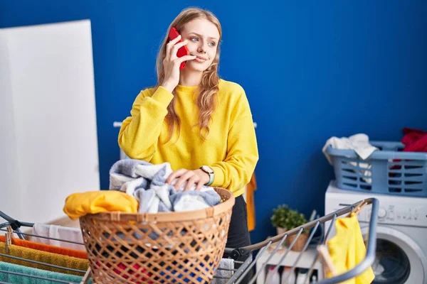 Young Blonde Woman Talking Smartphone Hanging Clothes Clothesline Laundry Room — Stockfoto