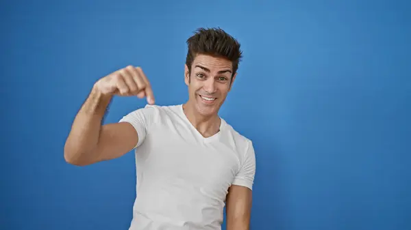 stock image Young hispanic man smiling confident standing over isolated blue background