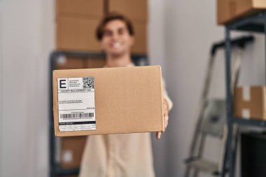 Young caucasian man ecommerce business worker holding package at office