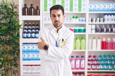 Eczanede çalışan yakışıklı İspanyol adam kış soğuğu yüzünden titriyor ve donuyor. Yüzünde üzgün ve şok ifadesi var. 