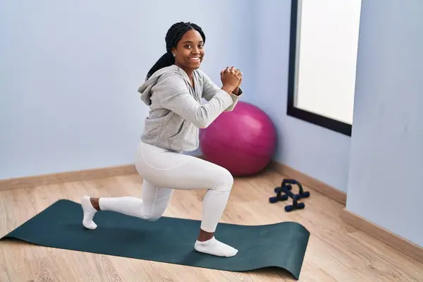 African american woman smiling confident training legs exercise at sport center