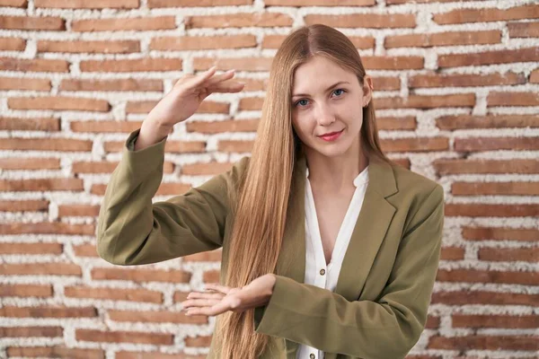 Young Caucasian Woman Standing Bricks Wall Background Gesturing Hands Showing — Foto Stock
