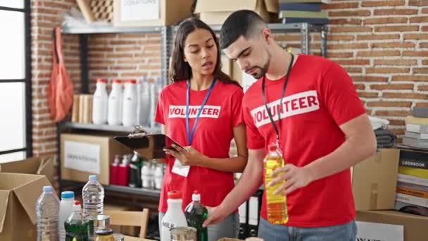 Beautiful Young Activists Volunteering Charity Center Man Woman Checking Products — Stock Video