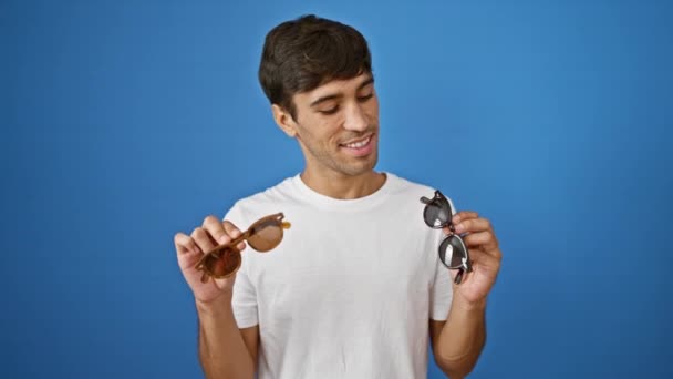 Cheerful Young Hispanic Man Confidently Choosing Cool Sunglasses Joy Radiating — Stock Video