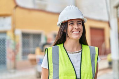 Young beautiful hispanic woman architect smiling confident standing at street