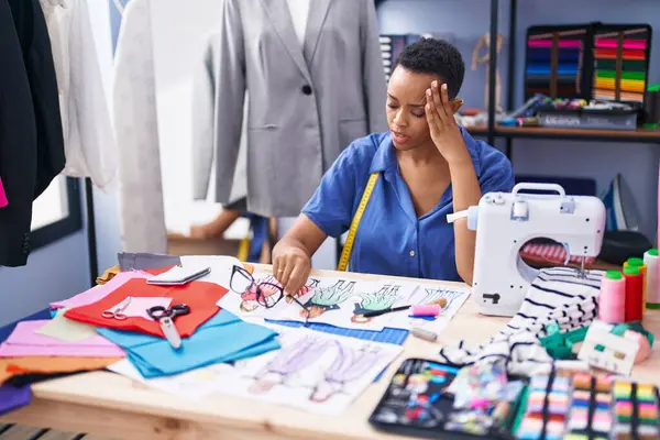 African american woman tailor stressed working at tailor shop