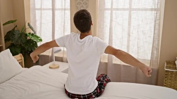Domowe Poranne Ujęcie Atrakcyjnego Młodego Latynosa Wygodnie Zrelaksowanego Przytulnej Sypialni — Wideo stockowe