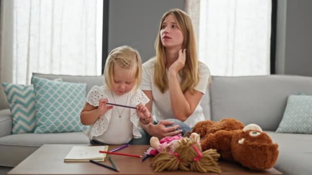 Mãe Estressada Relaxando Sofá Casa Enquanto Pequena Filha Caucasiana Envolve — Vídeo de Stock