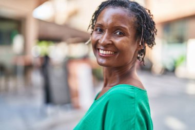 Middle age african american woman smiling confident standing at street