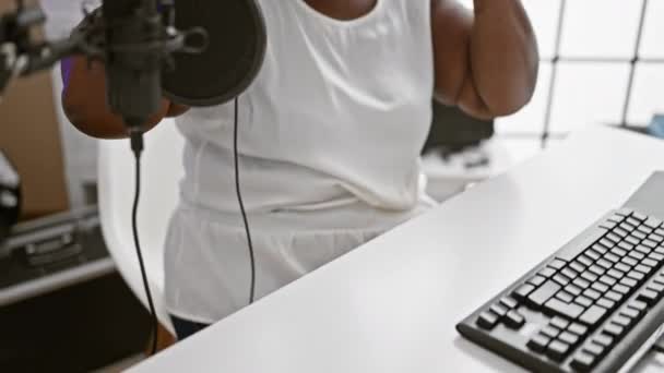 African American Woman Reporter Wearing Headphones Presenting News Radio Studio — Stock Video