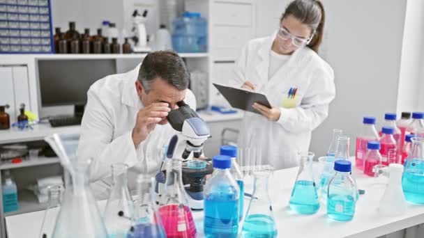 Male Female Scientists Working Together Lab Serious Concentration Research Writing — Stock Video