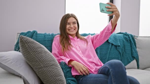 Cheerful Young Hispanic Woman Captures Joyful Selfie Photo Smartphone Sitting — Stock Video
