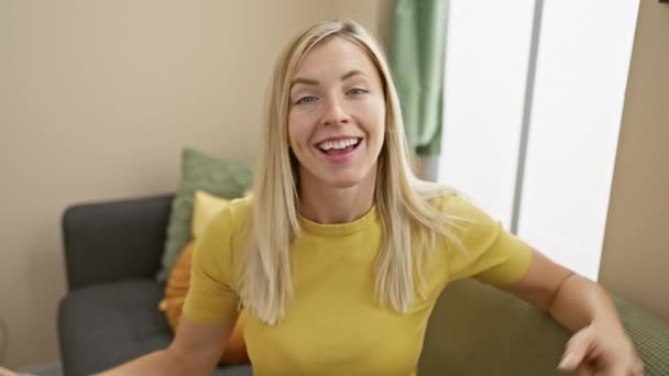 Joyful Young Blonde Woman Pointing Perfect Teeth Smiling Cheerfully Home — Stock Video