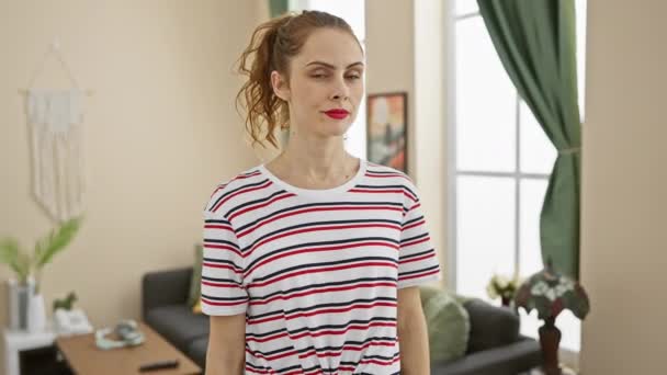 Confident Woman Showing Muscles Striped Shirt Portraying Strength Empowerment Cozy — Stock Video