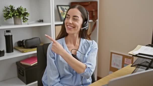 Cheerful Young Hispanic Woman Pointing Smiling Office Sporting Beautiful Headset — Stock Video