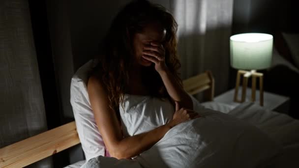 Distressed Young Woman Sitting Bed Dimly Lit Bedroom Covering Her — Stock Video