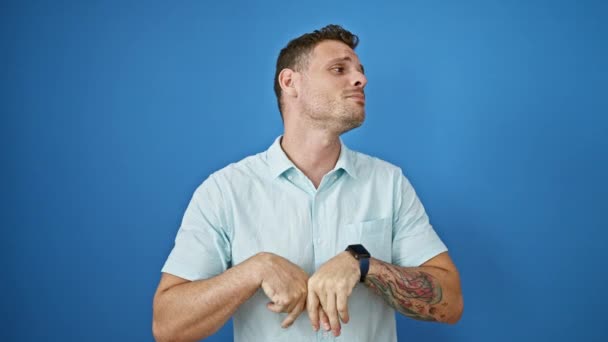 Hispanic Man Tattoos Smiles While Using Smartphone Blue Isolated Background — Stock Video