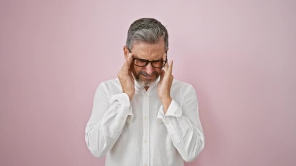 Frustrated Young Hispanic Man Grey Haired Takes Glasses Isolated Pink — Stock Video