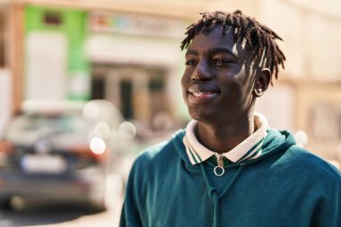 African american man smiling confident looking to the side at street