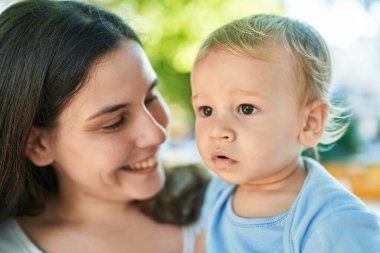 Mother and son smiling confident standing at park
