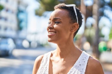 African american woman smiling confident looking to the side at street