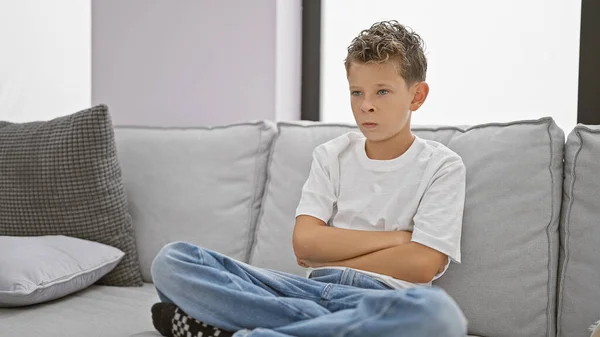 Adorable Blond Boy Sitting Cozy Living Room Arms Crossed Upset — Stock Photo, Image