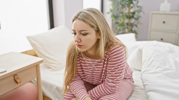 Contemplative Young Blonde Woman Sits Cozy Bedroom Setting Exuding Casual — Stock Photo, Image