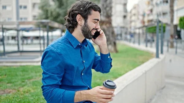 Young Hispanic Man Talking Smartphone Drinking Coffee Park — Stock fotografie