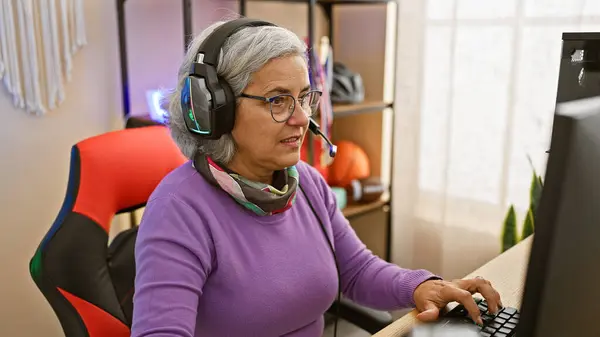 Middle Aged Woman Engages Gaming Indoors Wearing Headphones Glasses Illuminating — Stock Photo, Image