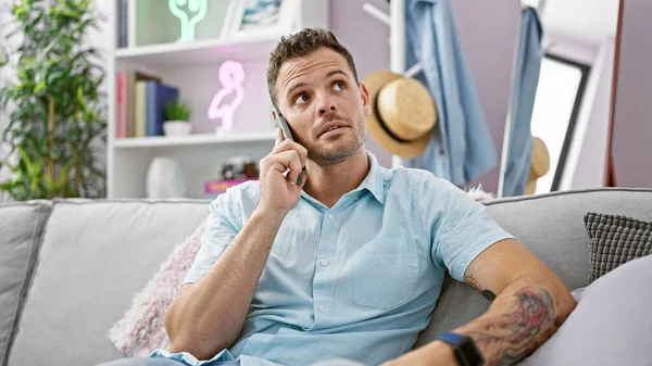 Pensive Hispanic Man Beard Casual Shirt Talking Phone While Lounging — Stock Photo, Image