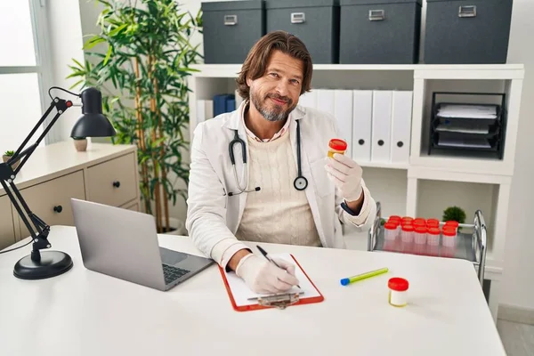 Middle Age Man Doctor Writing Document Holding Urine Test Tube — Stock Photo, Image