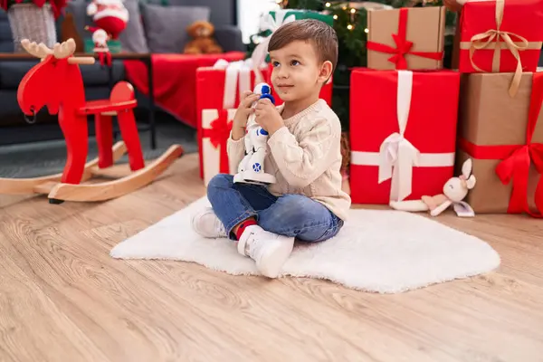 Adorable Hispanic Boy Playing Robot Toy Sitting Floor Christmas Tree Royalty Free Stock Photos